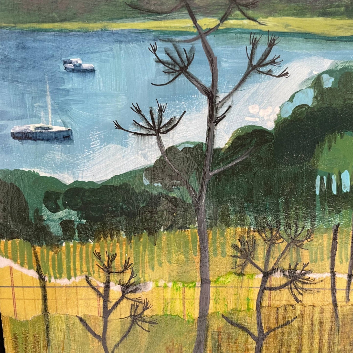 Detail of Aegean Autumn mixed media original landscape by Elaine Boylan. View of Gümüşlük bay on the Bodrum Peninsula in Turkey. Close up of turquoise sea with boats, field in the foreground showing collage and brushstrokes. Colours are mainly greens, golds and blues. Materials are collage and acrylic paint on board.